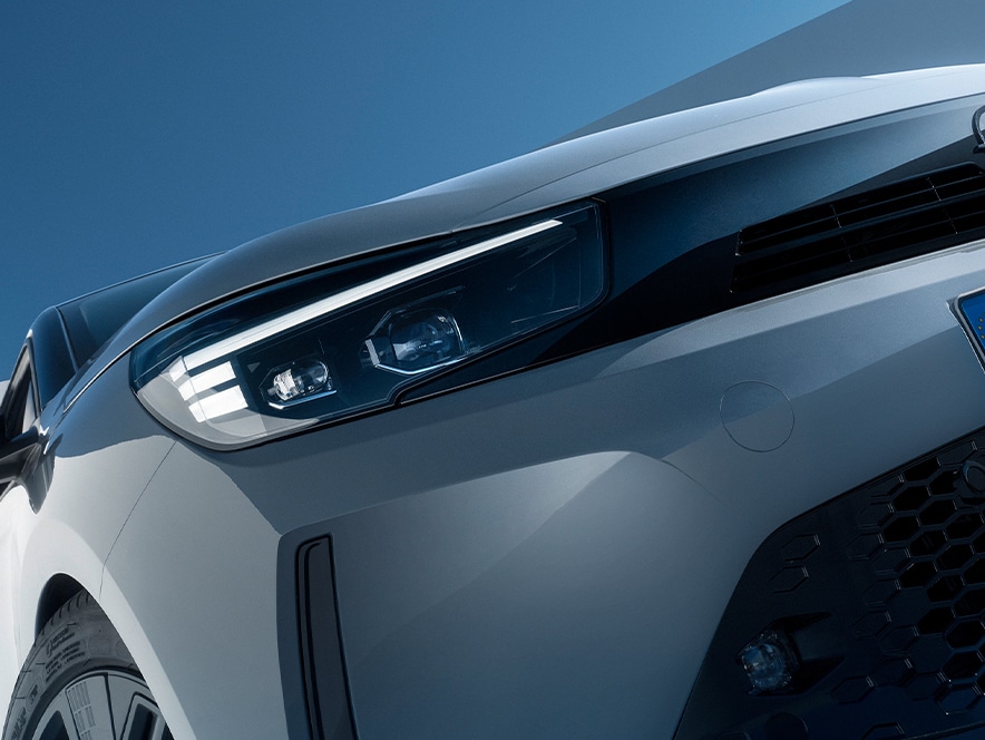 Close-up of the IntelliLux Matrix LED headlight of a grey Opel Corsa Electric with black alloys